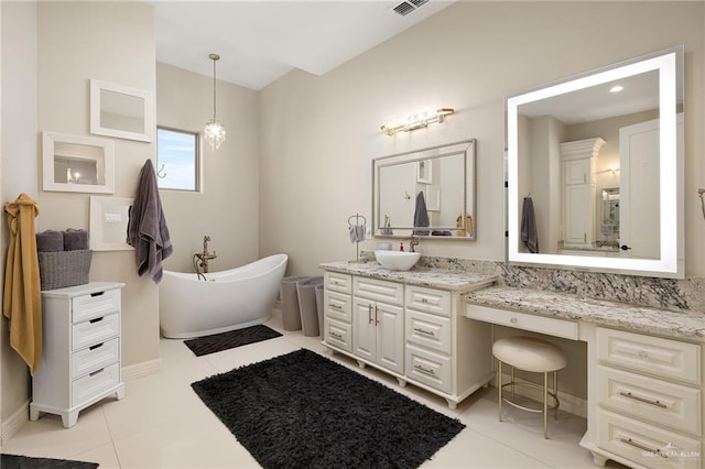 bathroom with vanity, tile patterned floors, and a bathtub