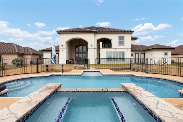 view of swimming pool with french doors and an in ground hot tub