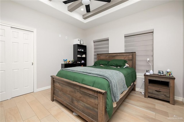 bedroom with a closet, ceiling fan, and light wood-type flooring