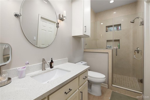 bathroom featuring vanity, walk in shower, and toilet