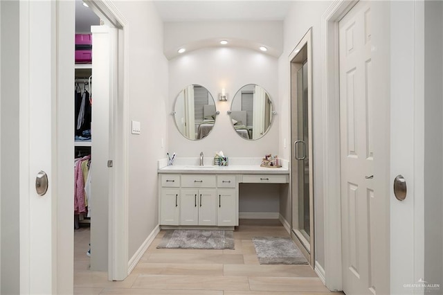 bathroom featuring vanity, an enclosed shower, and hardwood / wood-style floors