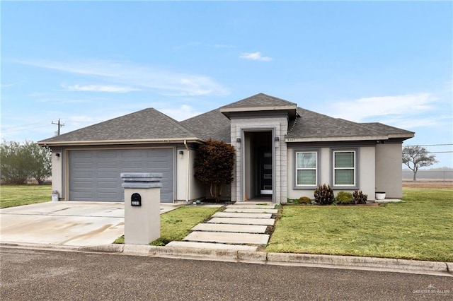 view of front of property featuring a garage and a front yard