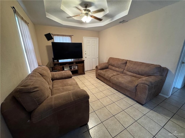411 N Fir St, Pharr, TX 78577 - living room with light tile patterned floors, a tray ceiling, and a ceiling fan