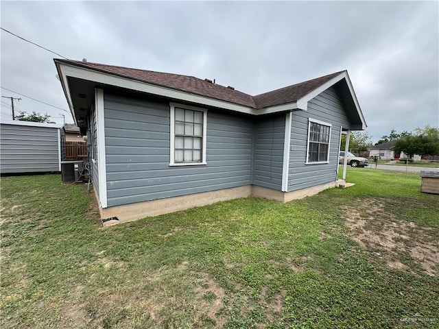 411 N Fir St, Pharr, TX 78577 - view of property exterior with a central AC unit and a lawn