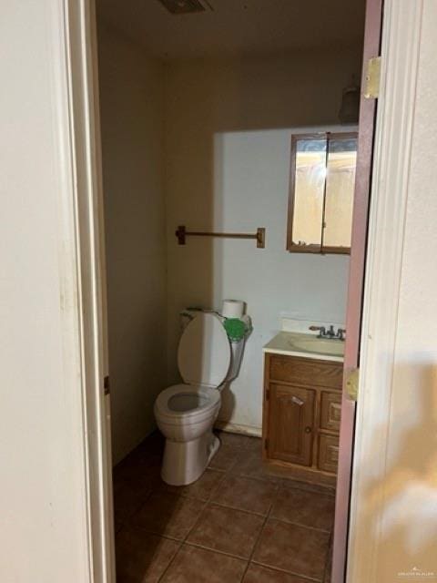 bathroom featuring tile patterned floors, vanity, and toilet