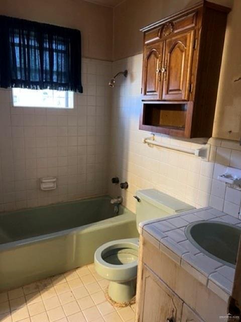 full bathroom featuring tasteful backsplash, vanity, tile walls, toilet, and tiled shower / bath