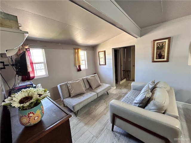 living room with plenty of natural light and lofted ceiling with beams