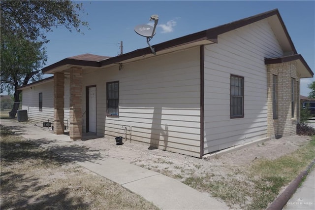 view of side of home featuring central AC unit