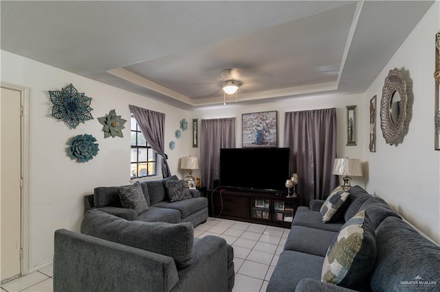 living room featuring light tile patterned floors and a tray ceiling