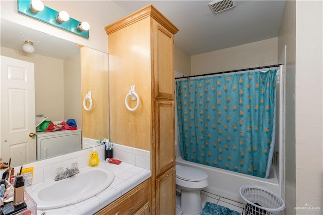 full bathroom with tile patterned floors, vanity, toilet, and shower / bath combo with shower curtain