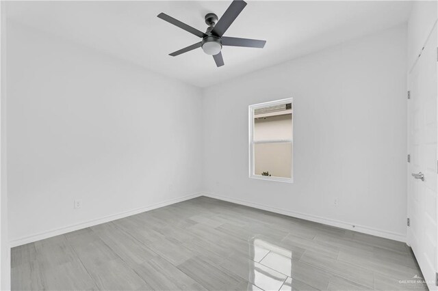 unfurnished room with ceiling fan and light wood-type flooring