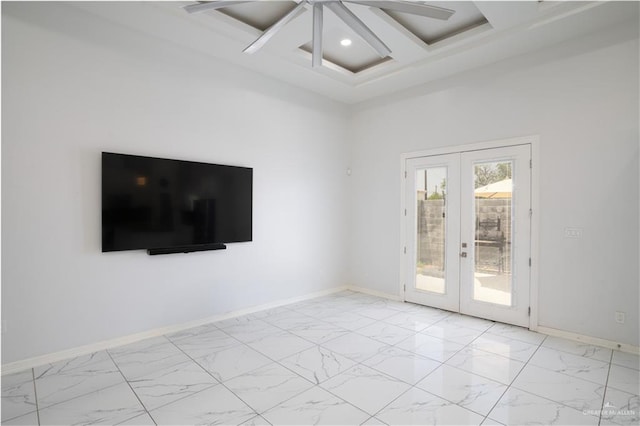 unfurnished room featuring coffered ceiling, beam ceiling, french doors, and a high ceiling