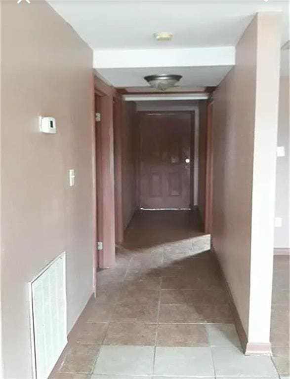 hallway featuring light tile patterned floors