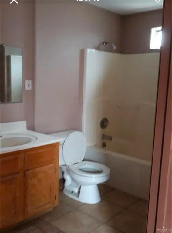 full bathroom with shower / washtub combination, vanity, tile patterned floors, and toilet