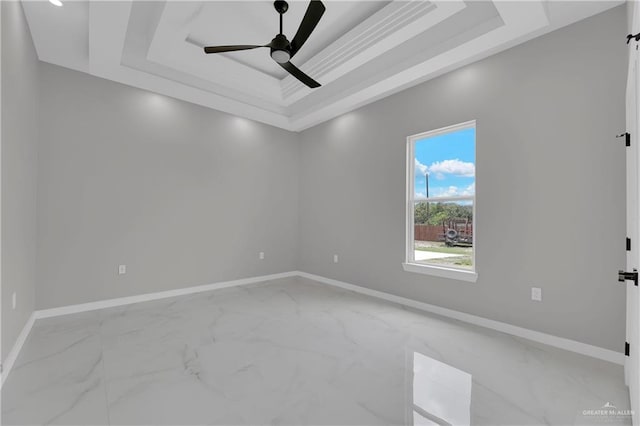 unfurnished room featuring ceiling fan and a tray ceiling