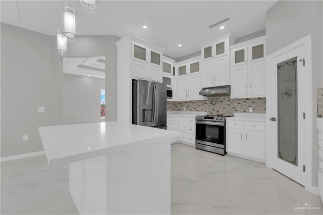 kitchen with hanging light fixtures, white cabinetry, appliances with stainless steel finishes, and backsplash