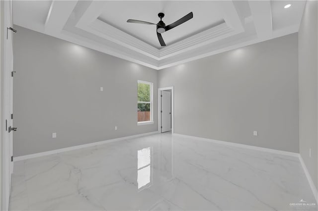 spare room with crown molding, a raised ceiling, and ceiling fan