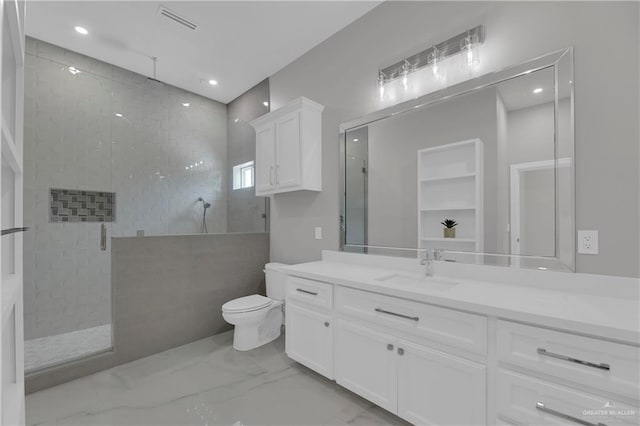 bathroom featuring vanity, an enclosed shower, and toilet