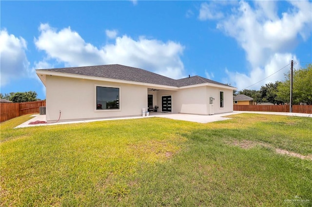 rear view of house featuring a patio and a lawn