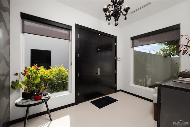 entryway featuring a notable chandelier and a healthy amount of sunlight