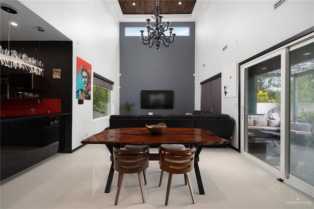 dining space with a high ceiling and a chandelier