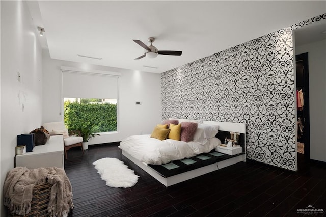 bedroom with dark hardwood / wood-style floors and ceiling fan