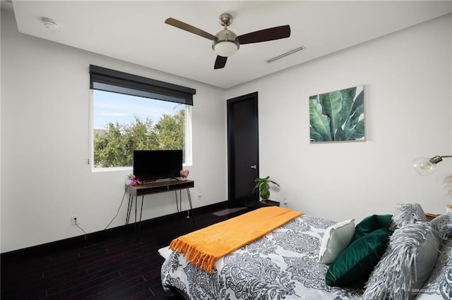 bedroom with ceiling fan and dark wood-type flooring