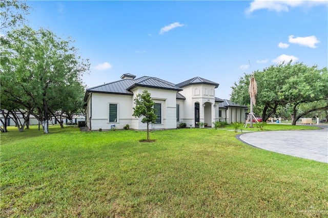 1412 E Mile 2nd Rd, Mission, TX 78574 - view of front of property with a standing seam roof, metal roof, a front lawn, and stucco siding