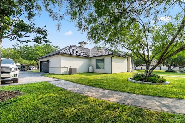1412 E Mile 2nd Rd, Mission, TX 78574 - view of side of home with a standing seam roof, metal roof, asphalt driveway, and a lawn