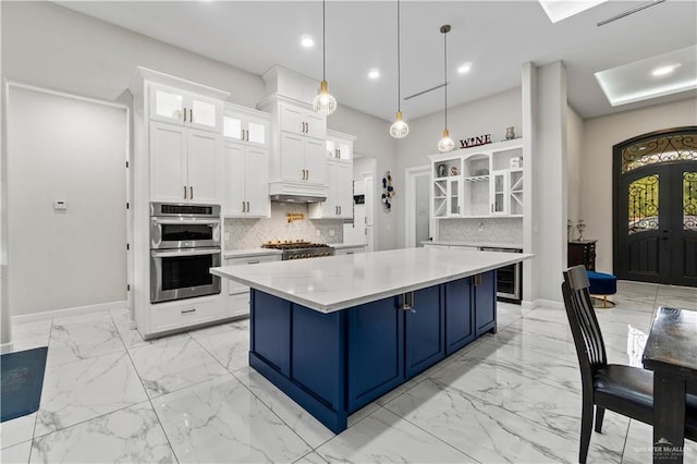 1412 E Mile 2nd Rd, Mission, TX 78574 - kitchen featuring open shelves, blue cabinets, light marble finish flooring, double oven, and beverage cooler