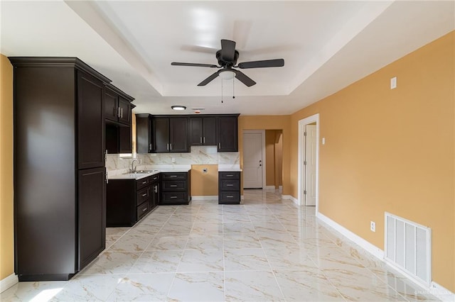 803 W Longoria St, Pharr, TX 78577 - kitchen featuring a tray ceiling, a sink, ceiling fan, and baseboards
