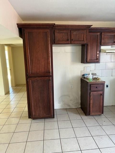 kitchen with tasteful backsplash and light tile patterned floors