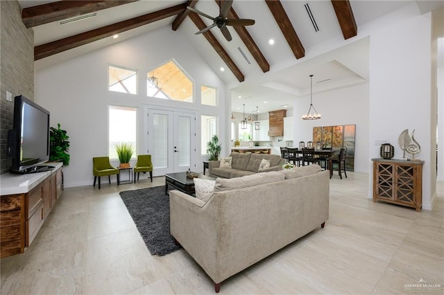 living room with beamed ceiling, french doors, ceiling fan with notable chandelier, and high vaulted ceiling