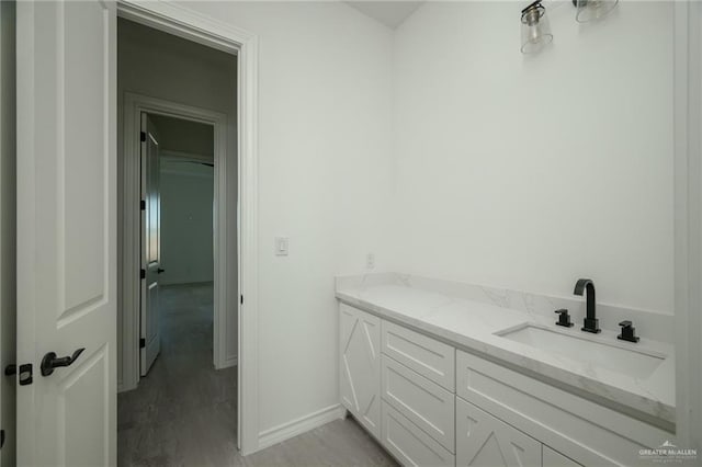 bathroom with hardwood / wood-style floors and vanity