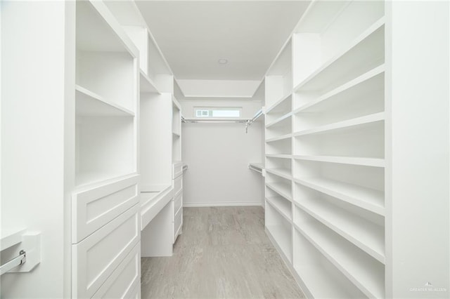 spacious closet with light hardwood / wood-style floors