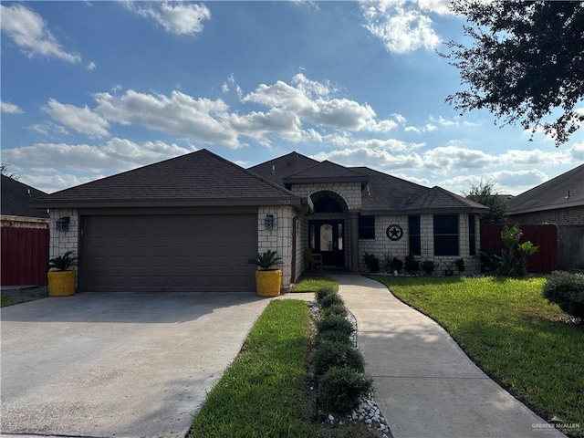 single story home with a garage and a front lawn