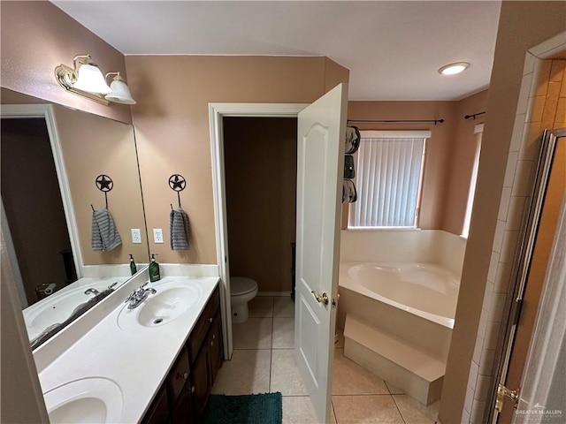 bathroom with toilet, a bath, vanity, and tile patterned floors