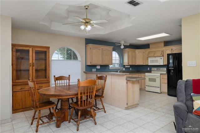 7207 Monroe St, Mission, TX 78572 - kitchen featuring white appliances, a raised ceiling, a peninsula, and a ceiling fan