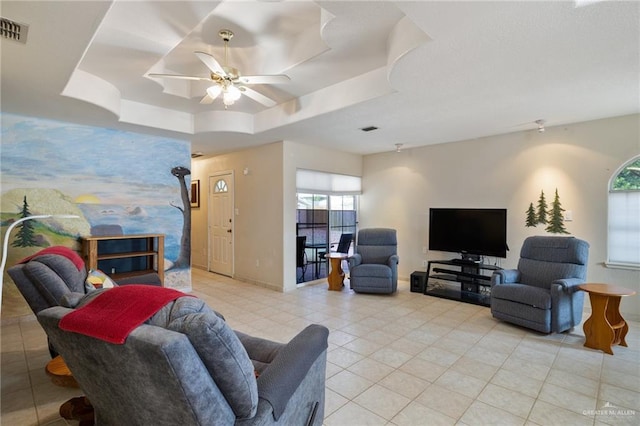 7207 Monroe St, Mission, TX 78572 - living room featuring light tile patterned floors, a ceiling fan, a raised ceiling, and baseboards