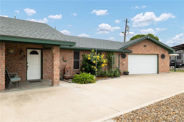 7207 Monroe St, Mission, TX 78572 - ranch-style home with brick siding, roof with shingles, concrete driveway, and a garage