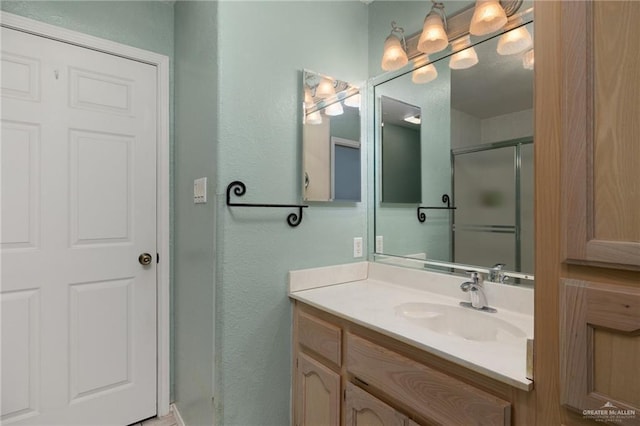 7207 Monroe St, Mission, TX 78572 - full bathroom with vanity, a stall shower, and a textured wall