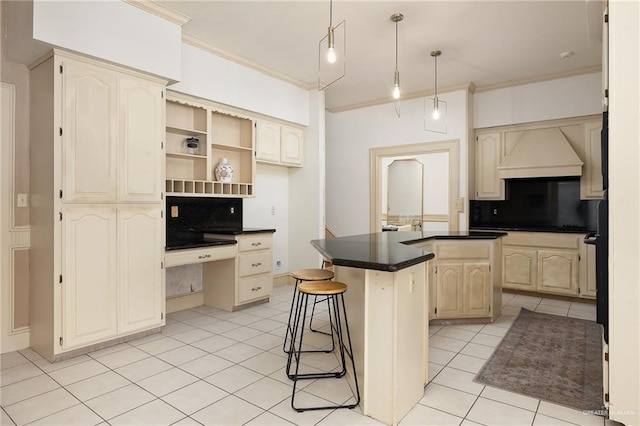 3703 N Glasscock Rd, Palmhurst, TX 78573 - kitchen with custom exhaust hood, light tile patterned floors, built in desk, ornamental molding, and dark countertops