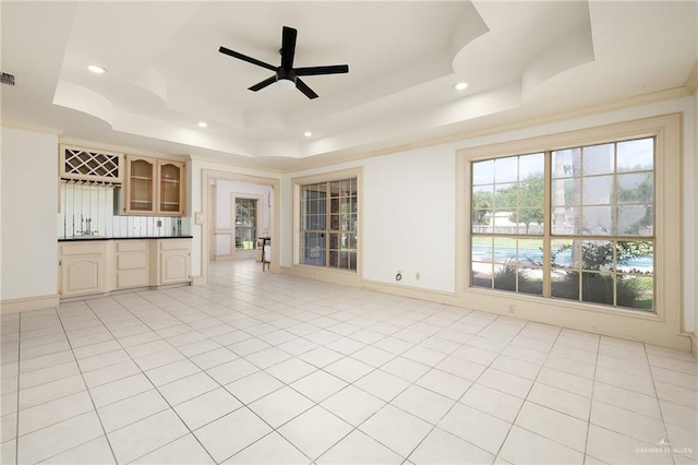 3703 N Glasscock Rd, Palmhurst, TX 78573 - unfurnished living room featuring a raised ceiling, wet bar, recessed lighting, ceiling fan, and light tile patterned flooring