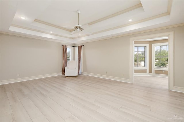 3703 N Glasscock Rd, Palmhurst, TX 78573 - spare room featuring a raised ceiling, healthy amount of natural light, a ceiling fan, ornamental molding, and light wood finished floors