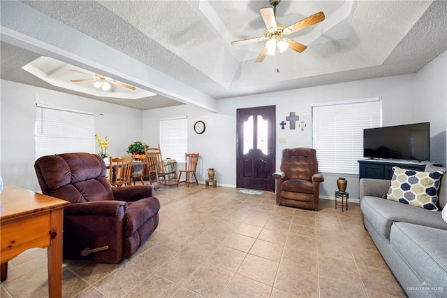 2309 W Chapin St, Edinburg, TX 78541 - living area featuring a raised ceiling, a ceiling fan, a textured ceiling, and light tile patterned floors