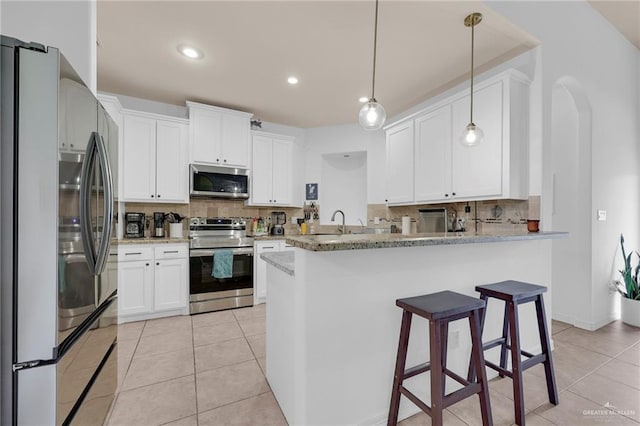 3604 Illeana St, Edinburg, TX 78539 - kitchen featuring stainless steel appliances, backsplash, light tile patterned floors, white cabinets, and recessed lighting