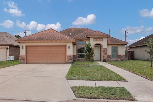 3604 Illeana St, Edinburg, TX 78539 - view of front facade with stucco siding, an attached garage, concrete driveway, and stone siding