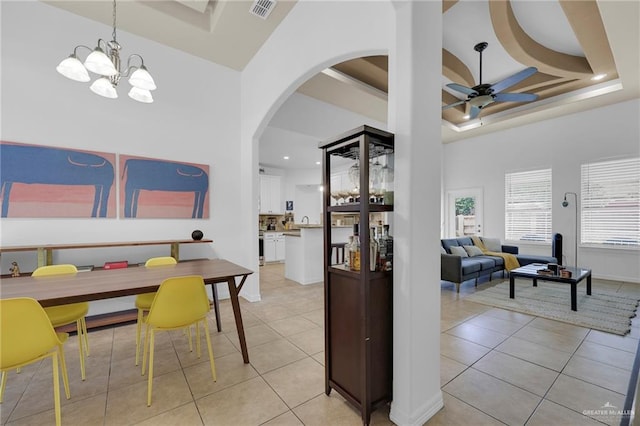 3604 Illeana St, Edinburg, TX 78539 - dining room featuring ceiling fan, arched walkways, light tile patterned flooring, a chandelier, and a towering ceiling