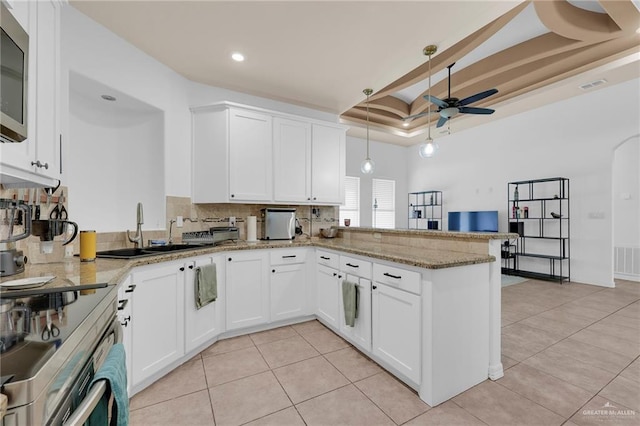 3604 Illeana St, Edinburg, TX 78539 - kitchen featuring backsplash, a ceiling fan, a raised ceiling, light tile patterned flooring, and recessed lighting