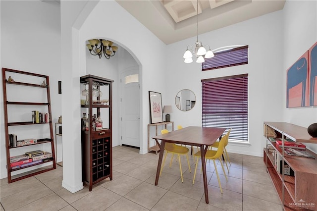 3604 Illeana St, Edinburg, TX 78539 - dining area featuring a chandelier, arched walkways, a towering ceiling, and light tile patterned floors
